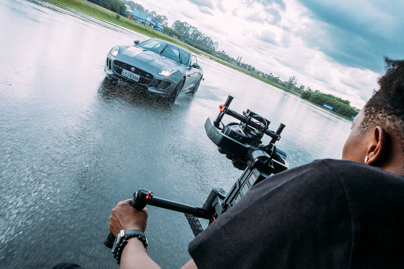 Behind the camera on a stabilized rig, filming a Jaguar F-Type on a wet track